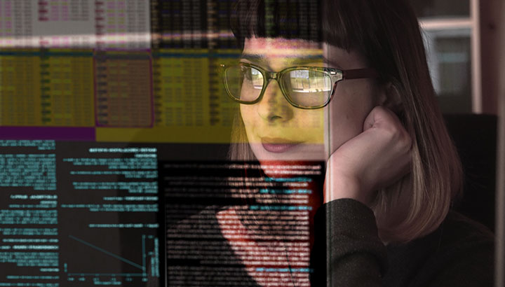 Lady with glasses looking at computer screen